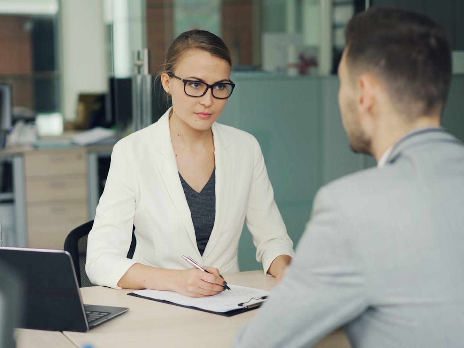 An interview taking place across an office desk